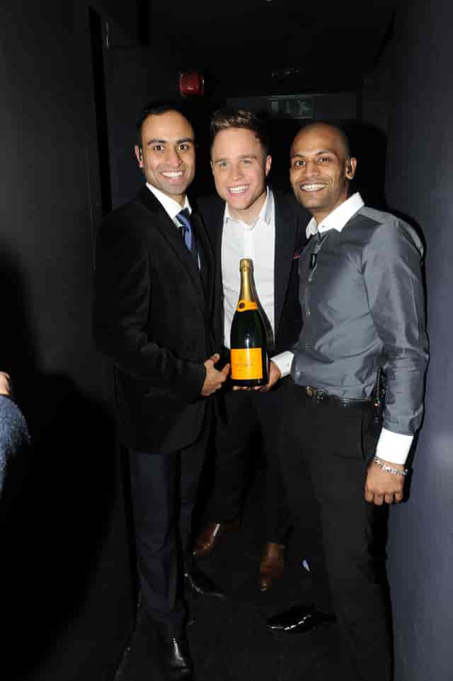 Group celebrating with champagne at The Main Bar, Bijou Club - networking event.