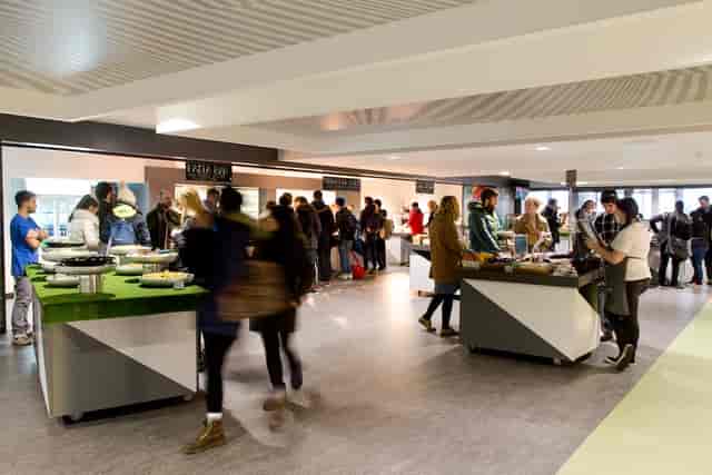Bustling Guild of Students courtyard event with food stations for networking.