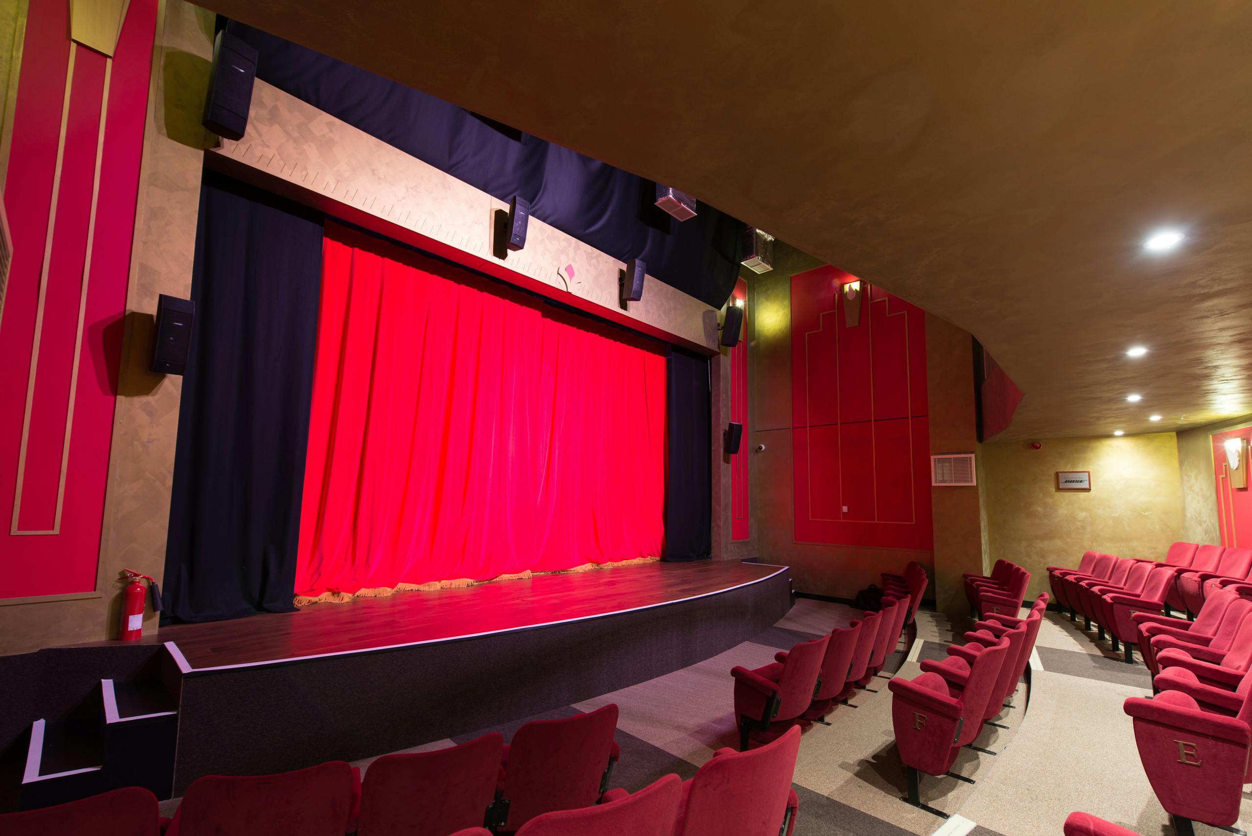 KidZania London Theatre with red curtain, ideal for performances and corporate events.