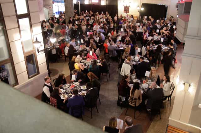 Main Square in KidZania London, elegant tables at a vibrant networking event.