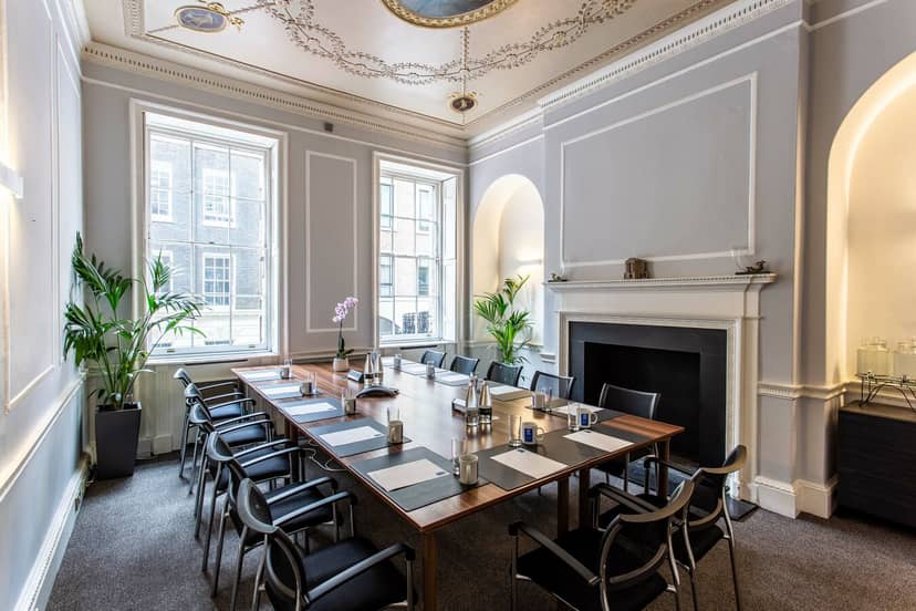 Bacchus Room in Adam House: elegant meeting space with large wooden table and natural light.