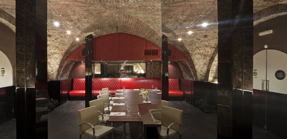 Stylish meeting space with arched brick ceilings, perfect for private events and executive meetings.