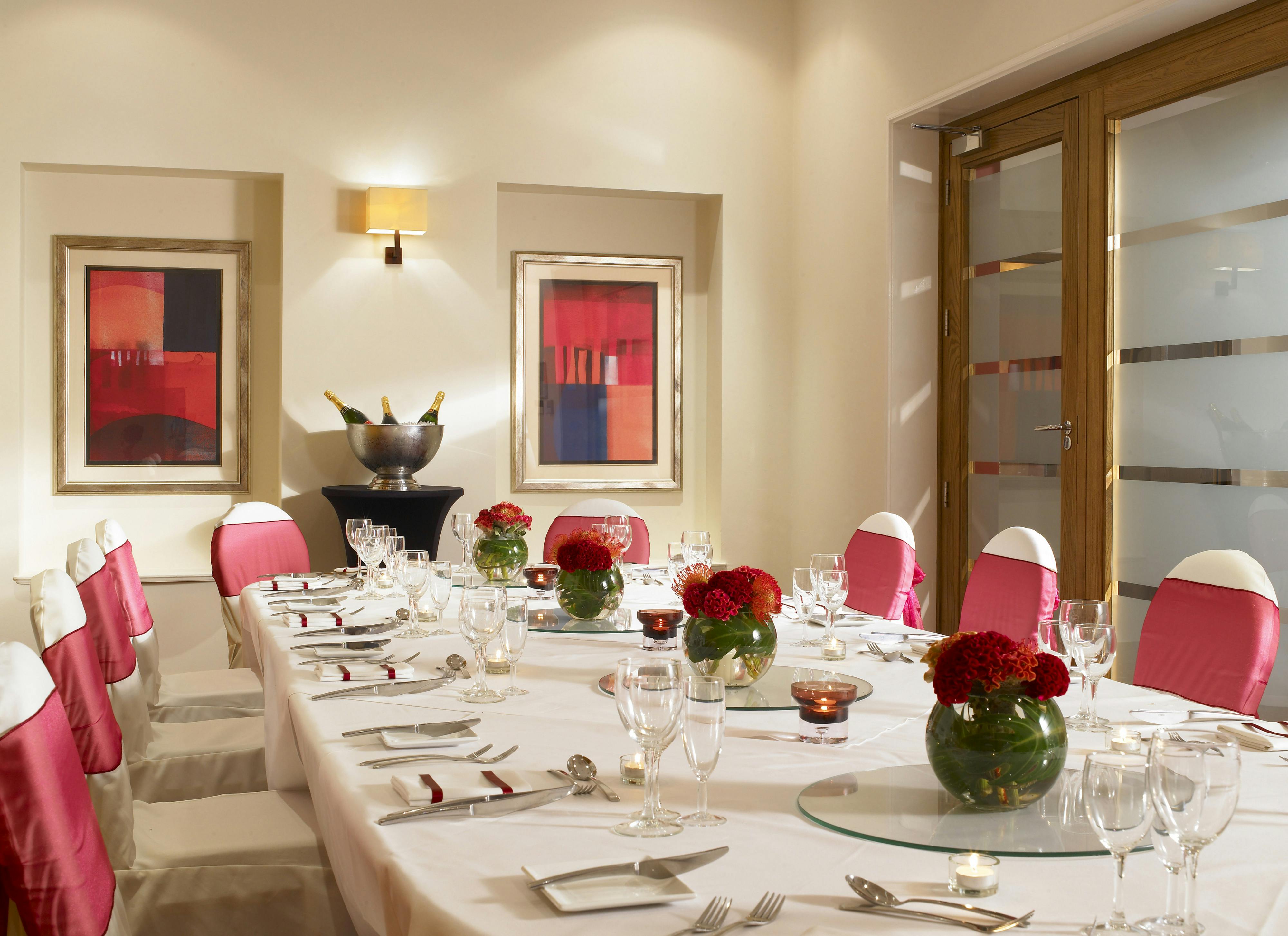 Elegant dining table with floral centerpieces at Birmingham Marriott Hotel event space.