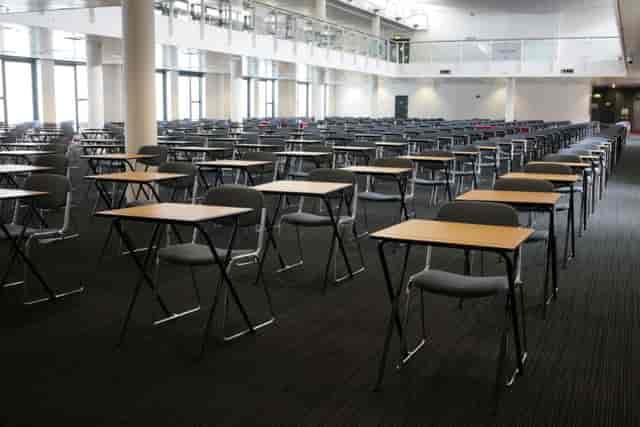 Spacious Business Design Centre atrium set for a conference with folding tables and chairs.