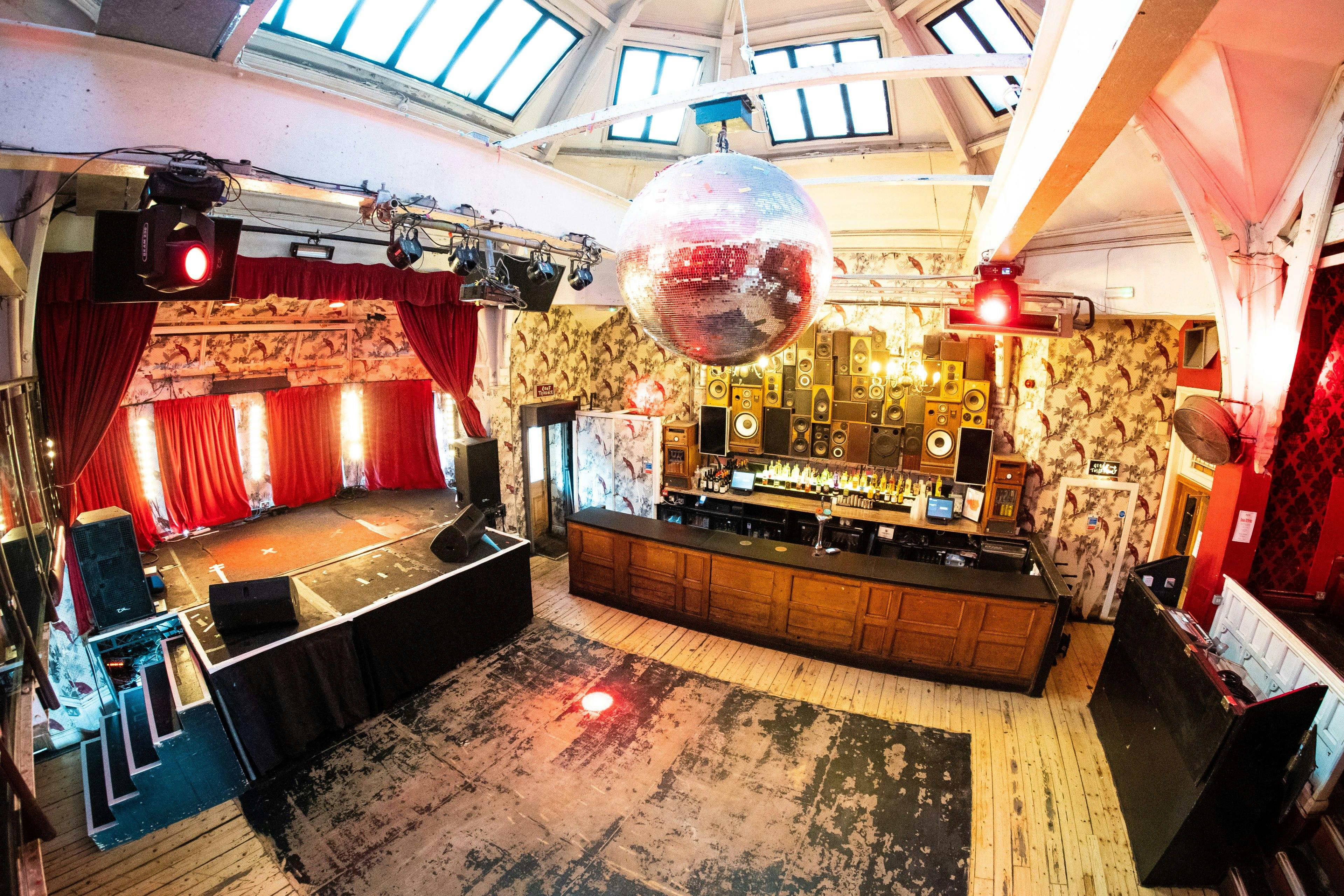 The Music Hall at The Deaf Institute with a spacious dance floor and disco ball for events.