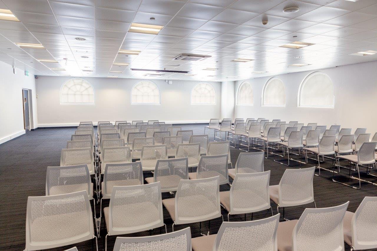 Versatile meeting space with modern chairs for events at Business Design Centre.