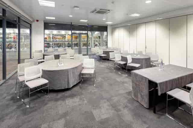 Versatile meeting space with natural light for workshops and networking events.