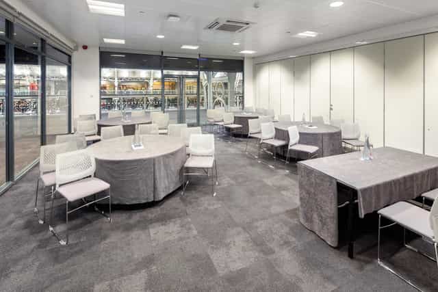 Versatile meeting space with natural light for workshops and networking events.