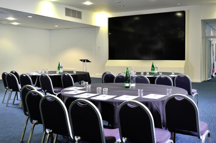 Professional meeting room at King Power Stadium with round table setup for events.