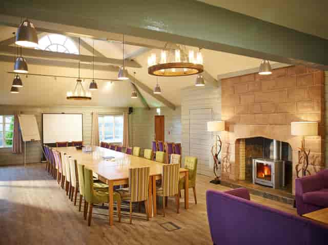 Forest Pavilion meeting space with fireplace, ideal for creative workshops and discussions.