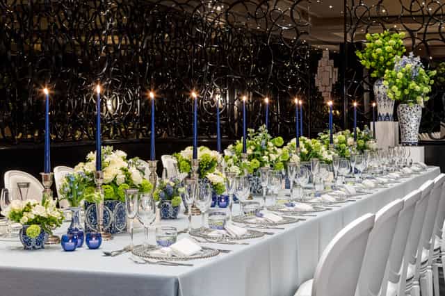 Elegant banquet table with blue and white decor for formal dinners or corporate events.