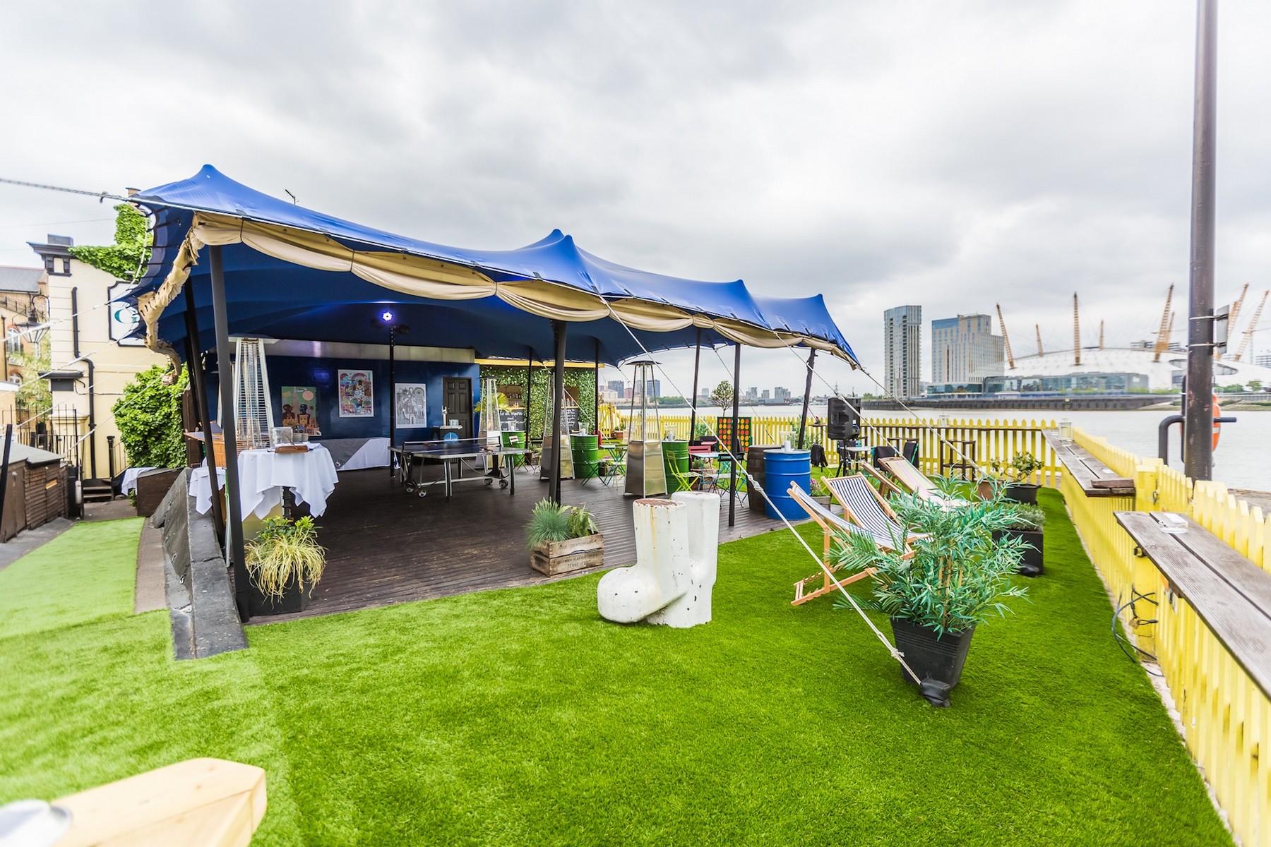 Gin Garden outdoor event space with blue canopy, ideal for meetings and gatherings.