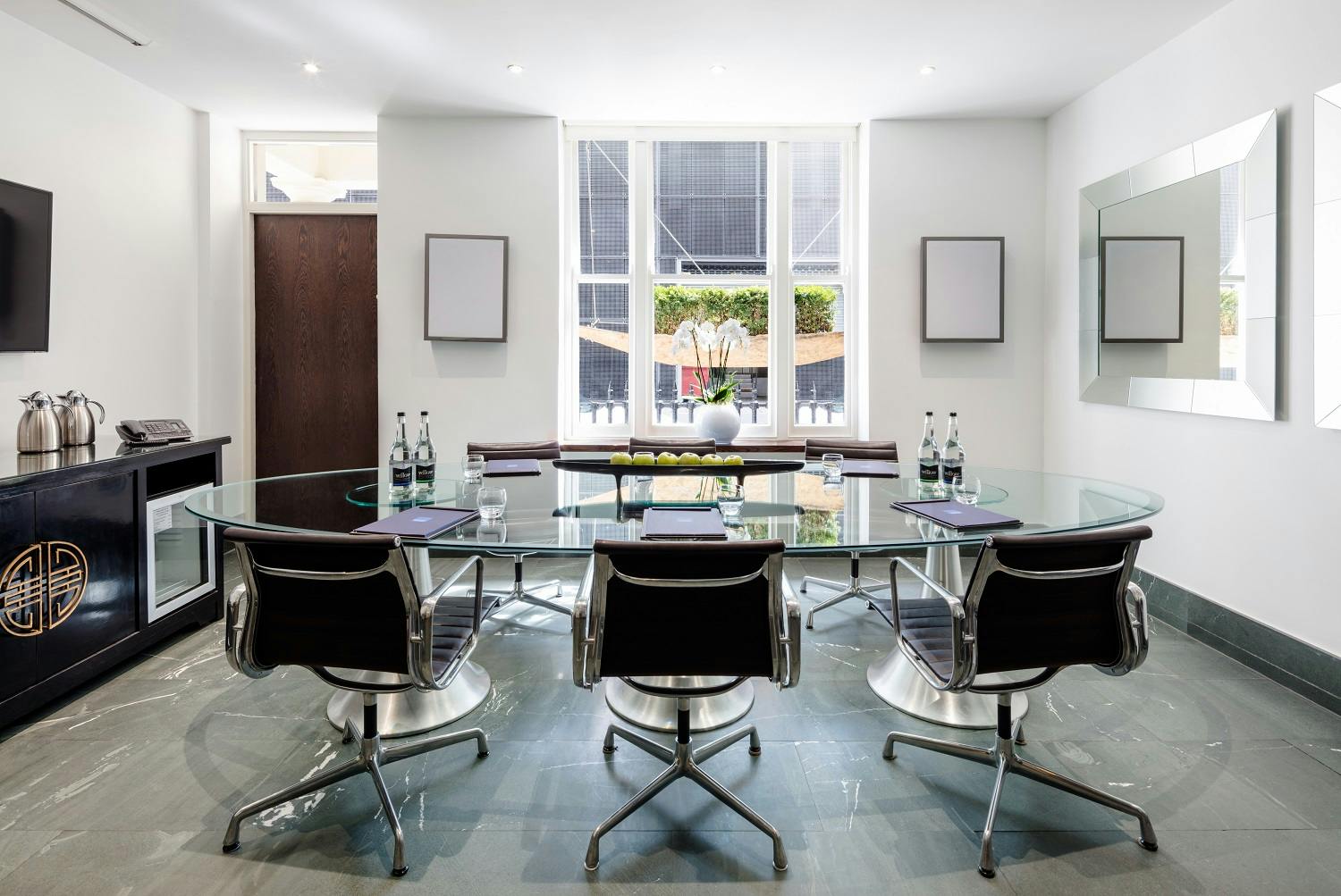 Modern meeting room with glass table for executive meetings at Radisson Blu Sussex.