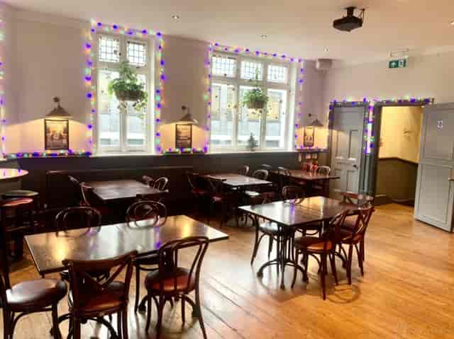 The Fox pub function room with festive string lighting for networking events and casual dining.