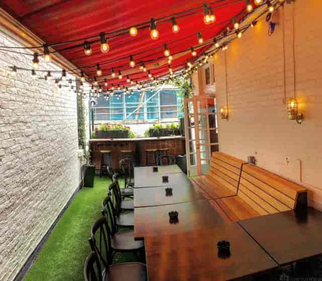 Modern function room and terrace with string lighting for networking and team-building events.