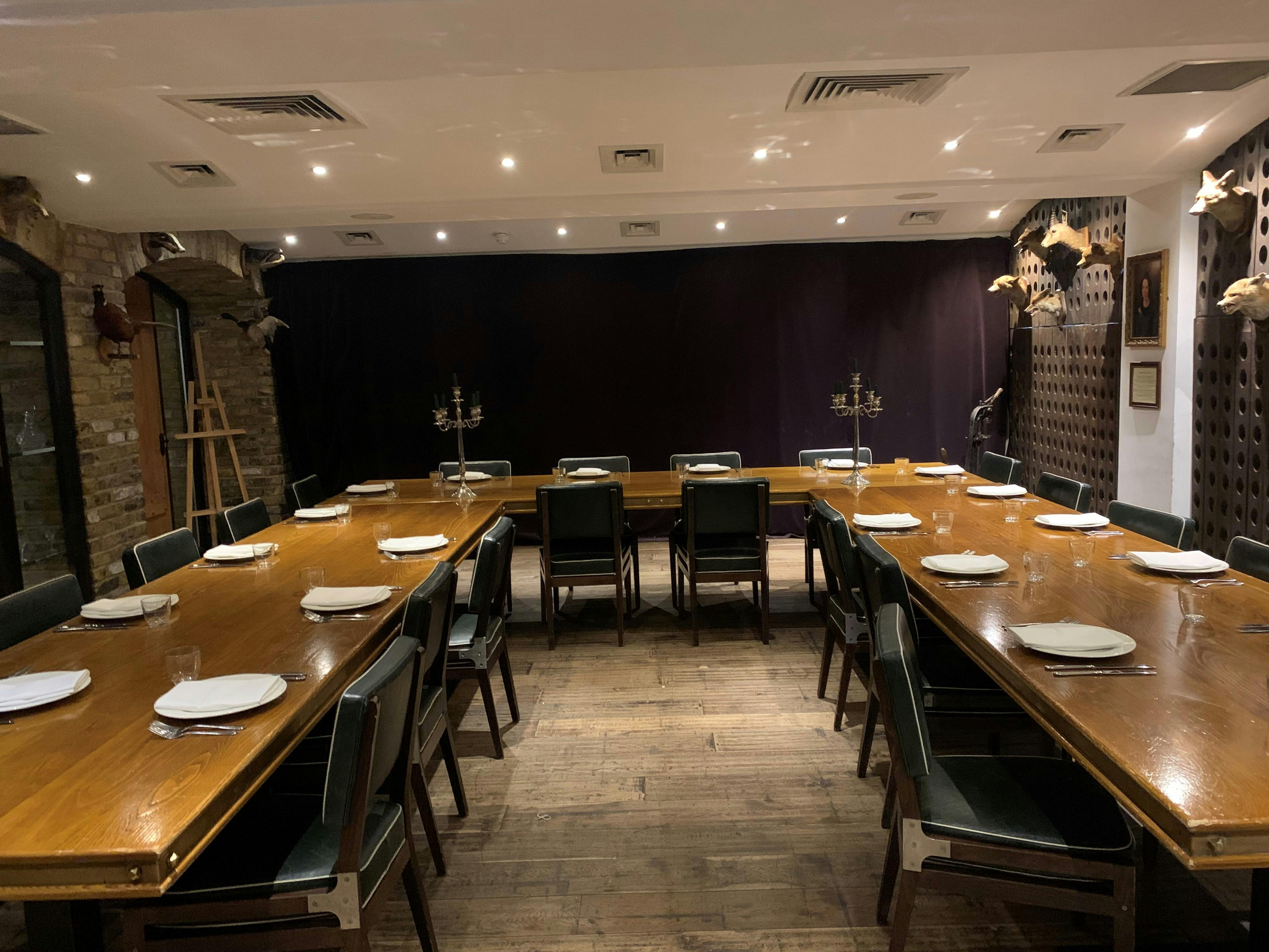 Elegant meeting room with wooden tables, perfect for corporate events and private dinners.