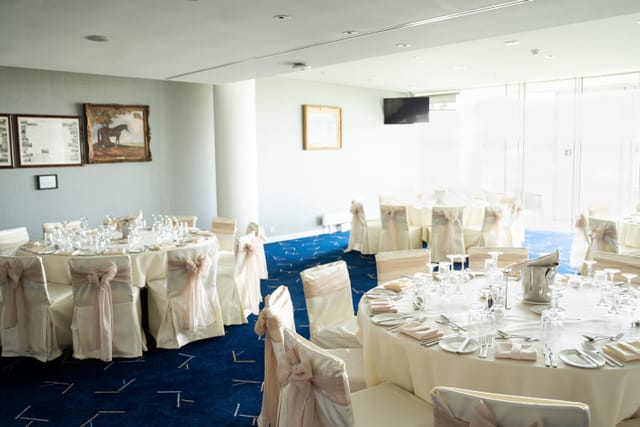 Royal Box at Epsom Downs: elegant wedding venue with cream linens and natural light.