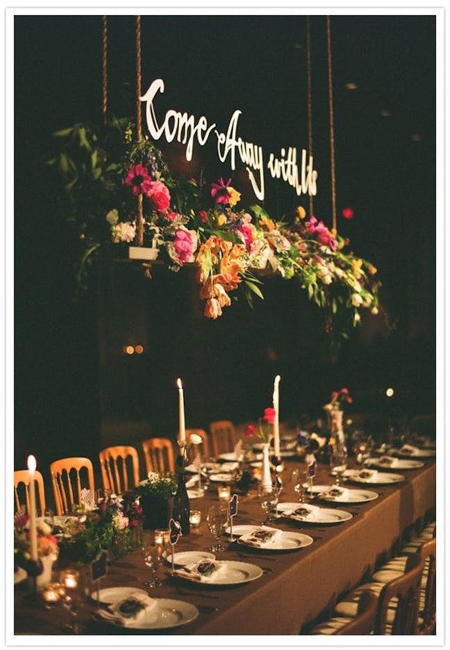 Hanging sign surrounded by flowers